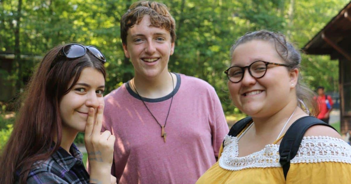 Three teens with smiling open faces at OTC