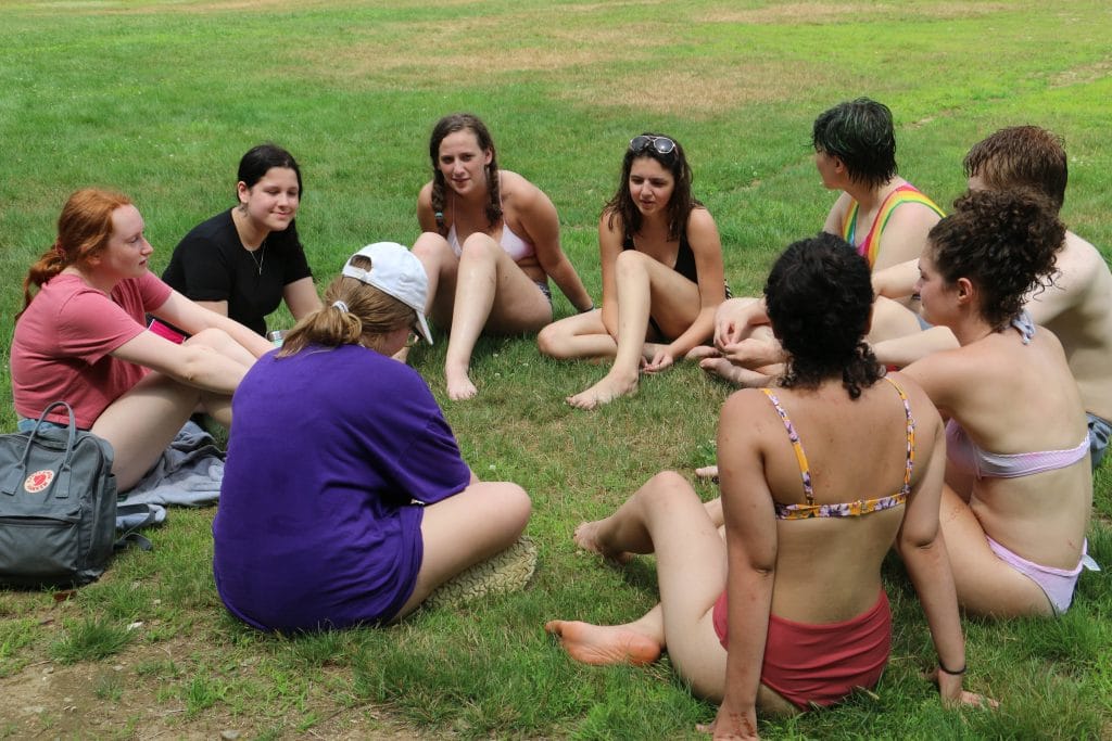 Ten campers sit in sharing circle