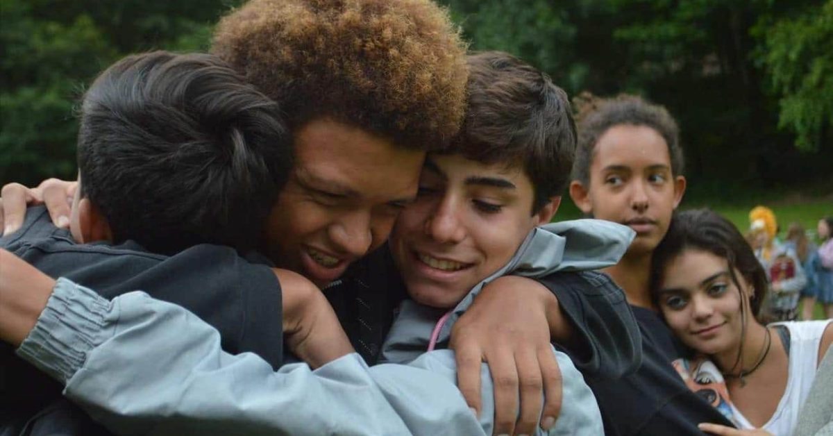 Group of teens hug goodbye intensely