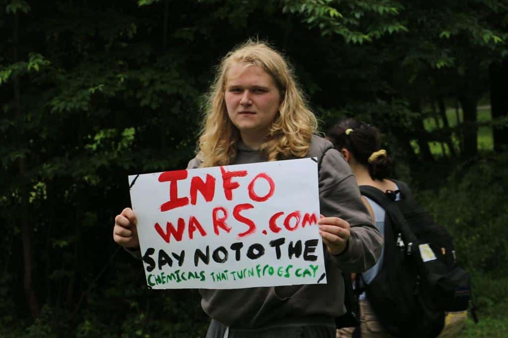 Teen holds up protesting sign at teen camp