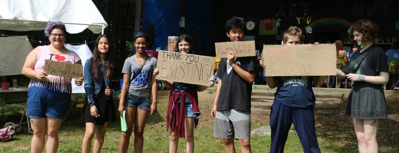 Campers show their protest signs