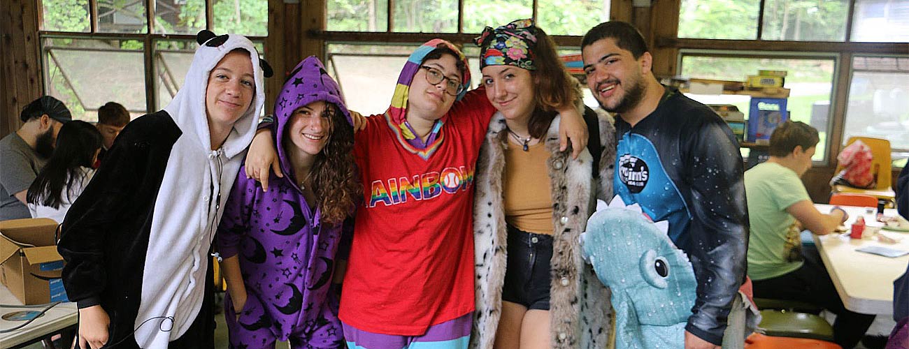Camp counselors pose in their pajamas during a lazy morning breakfast