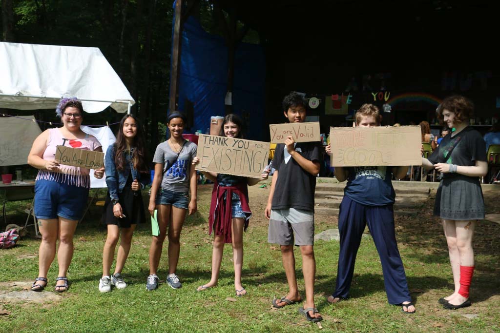 Campers hold up protesting signs