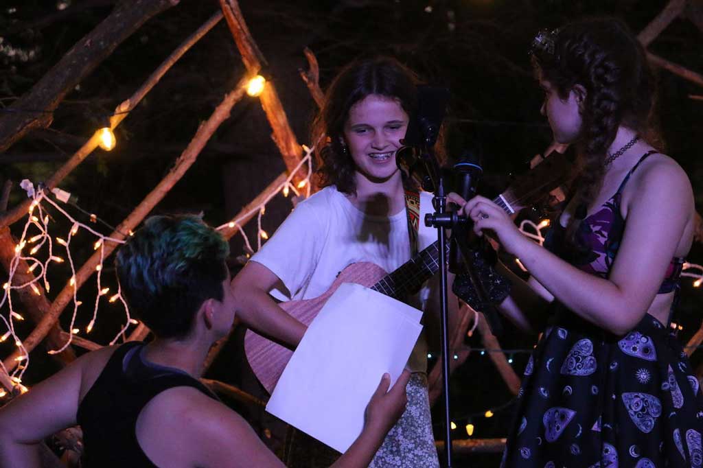Two campers performing a song on open mike night