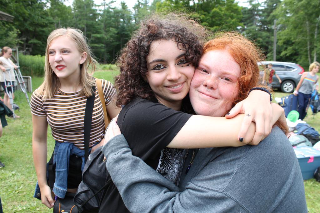 Two campers embrace for photo