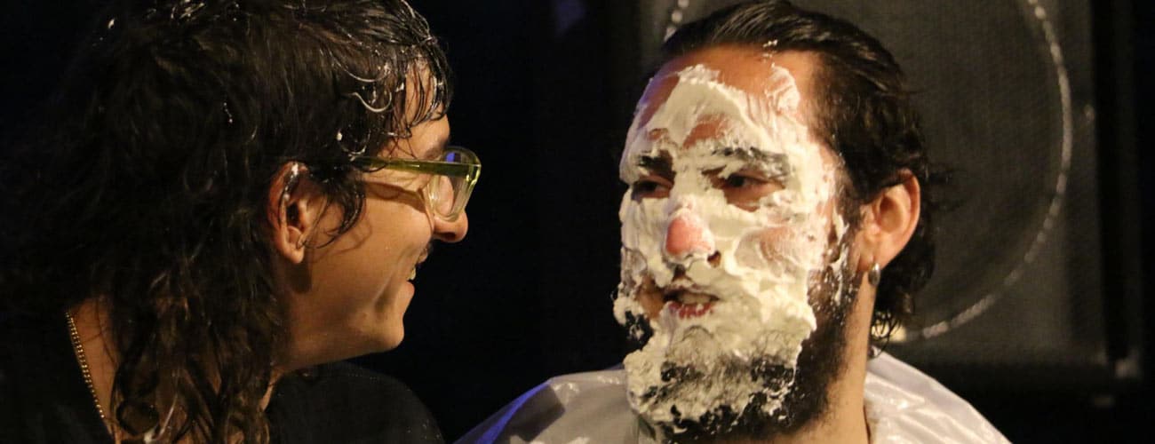 404 Error Banner - Georgious looks at his friend who has shaving cream on his face.