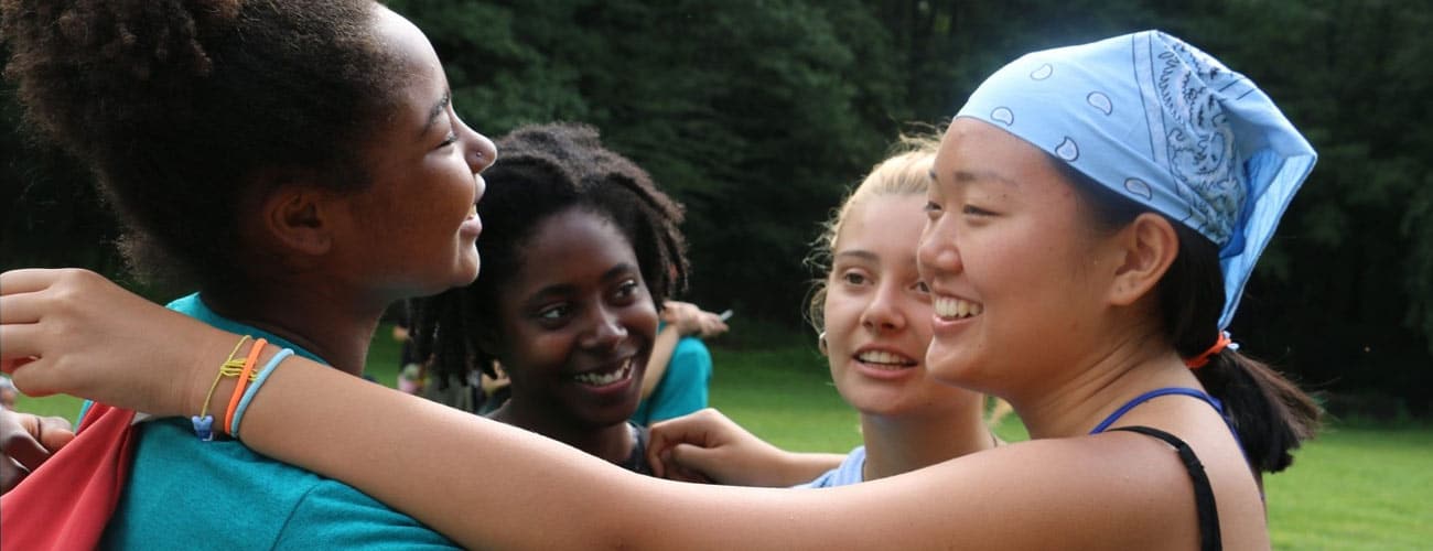 Three teens of different ethnicities, in a huddle