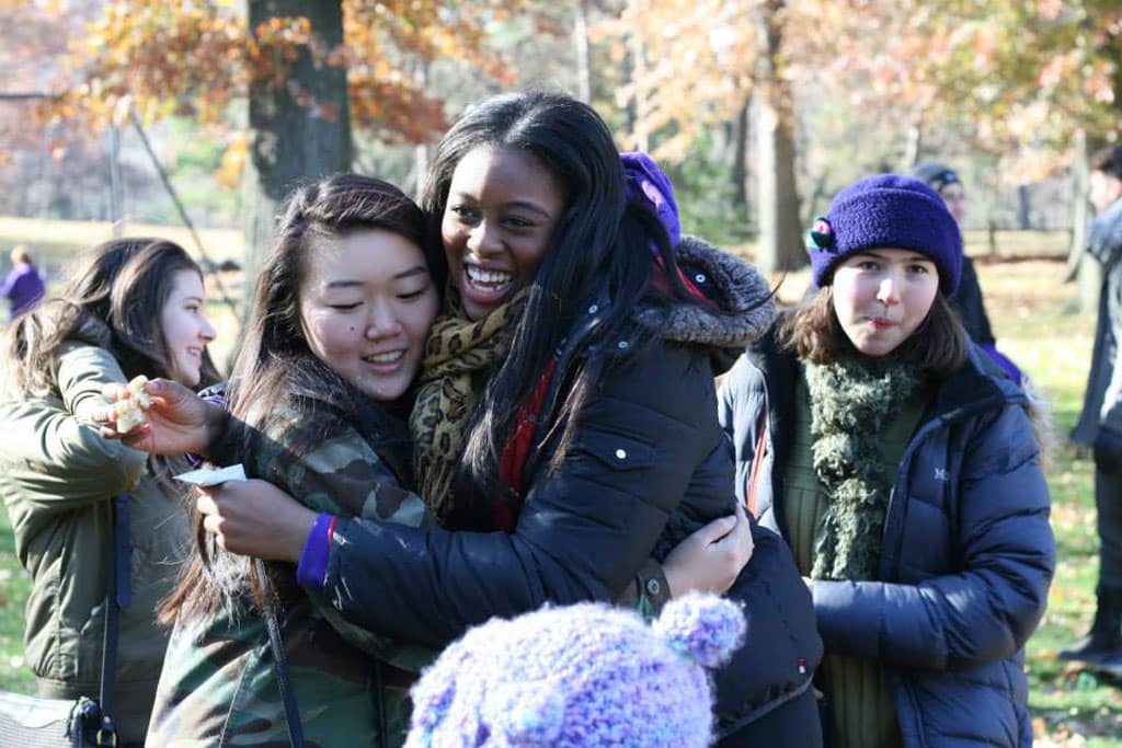 Teens hug at a camp reunion during the fall in NYC.