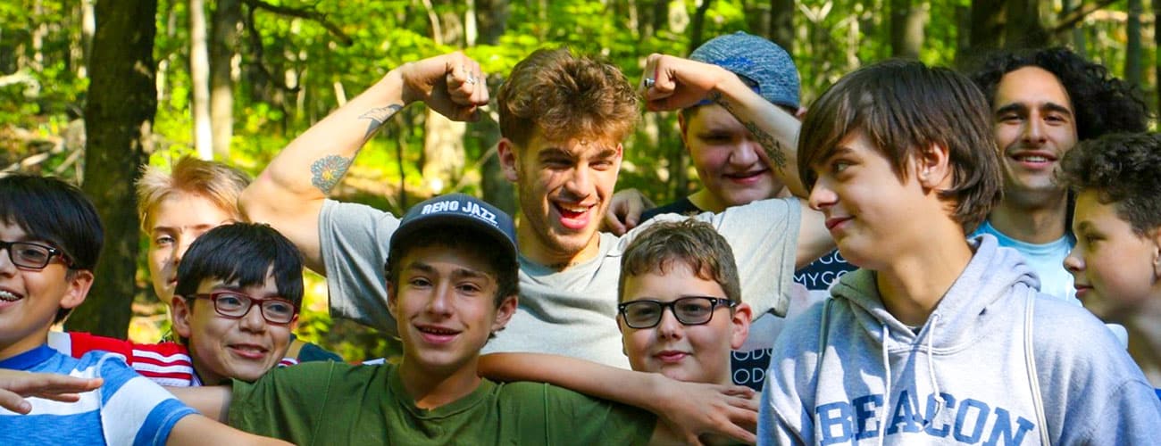 Jeremy Ruehlemann surrounded by younger boys at camp.