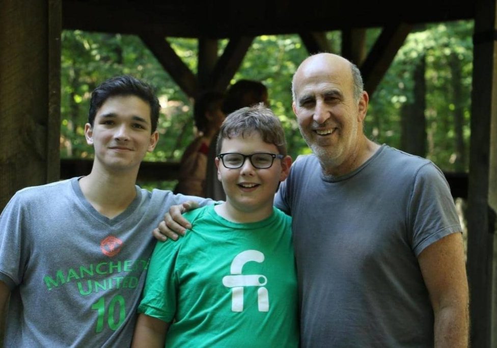 Adam Simon with two teens at camp